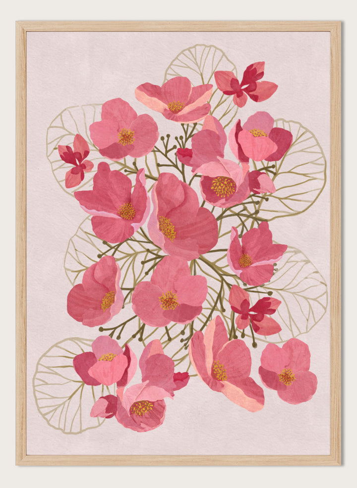 A framed botanical art print featuring pink flowers with yellow centers and delicate gold leaf outlines on a pale pink background. Shop Japanese Quince Floral Art Print by Katie O&