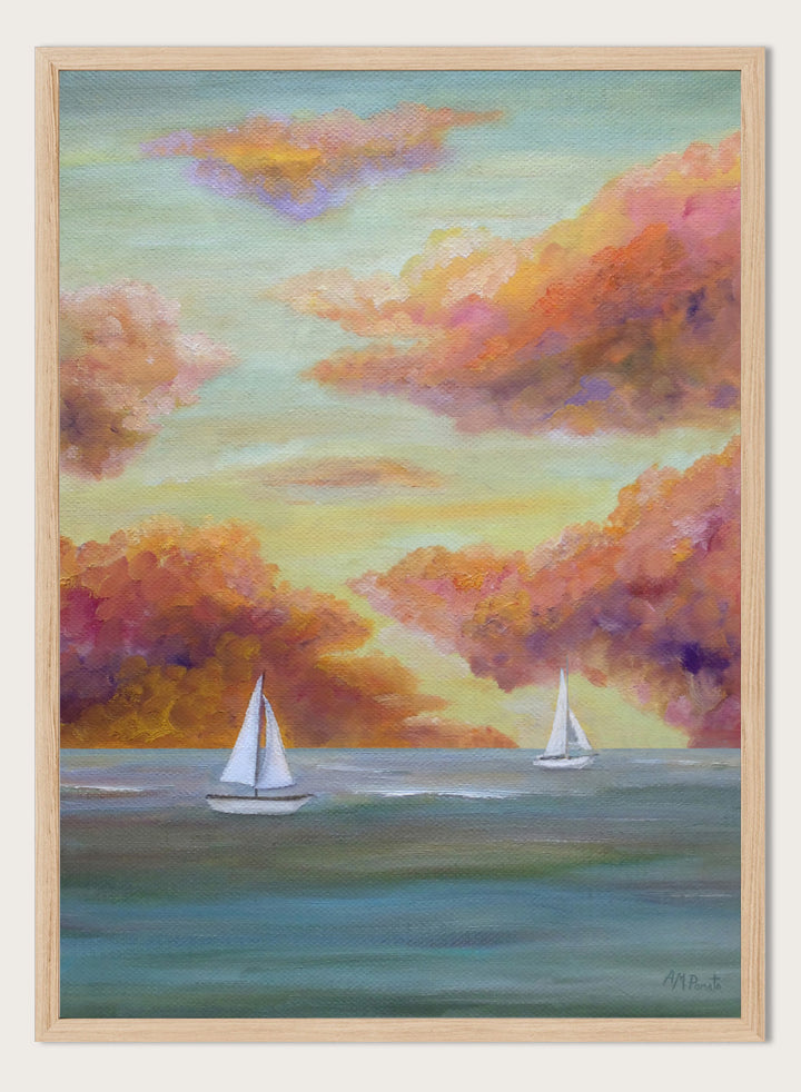 A framed painting of two white sailboats on a calm blue-green sea under a sky filled with soft, painterly clouds in pink, orange, yellow, and purple tones. Shop Sailboat Sunset Sky by Angeles M. Pomata, a coastal landscape art print featuring sailboats, calm water, and a glowing sunset sky.