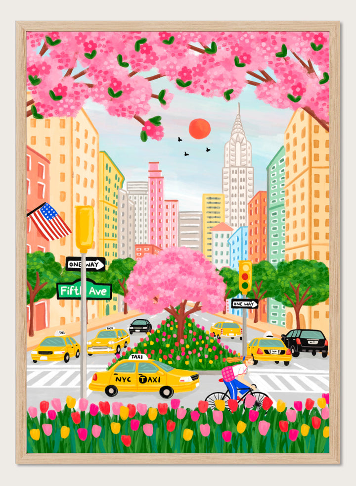 A colorful illustrated city street scene with pink cherry blossoms overhead, yellow NYC taxis, tall buildings, a bicycle with a pink basket, flowers in the foreground, and street signs including Fifti Ave. Shop NYC Cherry Blossoms by Nidhi Kachhadiya, a colorful New York City wall art print with Fifth Avenue, yellow taxis, pink blossoms, and spring city charm.