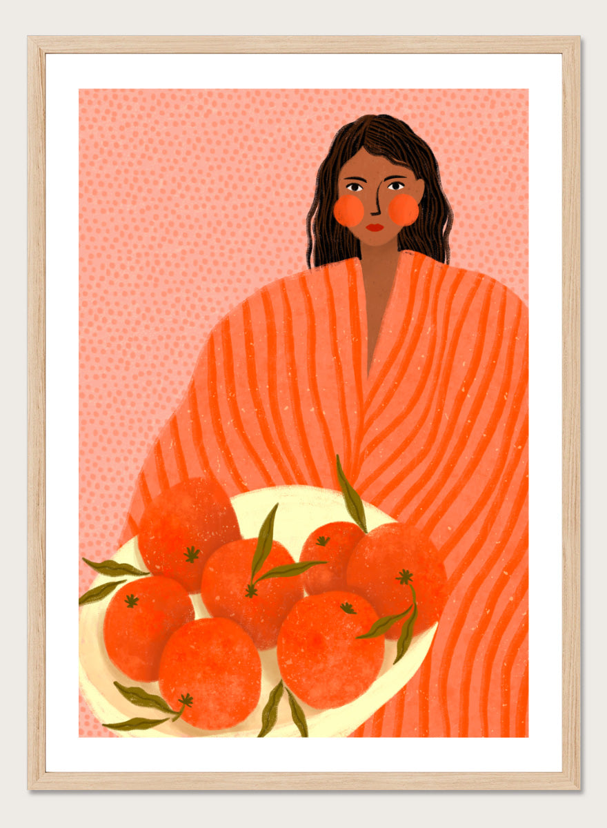 A stylized art print featuring a woman with dark hair wrapped in a bright orange striped blanket, holding a white plate of oranges against a pink dotted background. Woman Holding Oranges by Bea Müller colorful kitchen art print featuring a woman carrying fresh citrus fruit in warm orange and coral tones.
