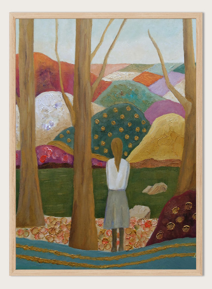 An expressive painting of a woman seen from behind standing among tall trees in a stylized landscape with colorful hills, patches of green, purple, pink, blue, and gold accents. Shop Woman Among Vibrant Hills by Angeles M. Pomata, a colorful landscape and portrait art print featuring a woman, rolling hills, trees, and earthy tones.