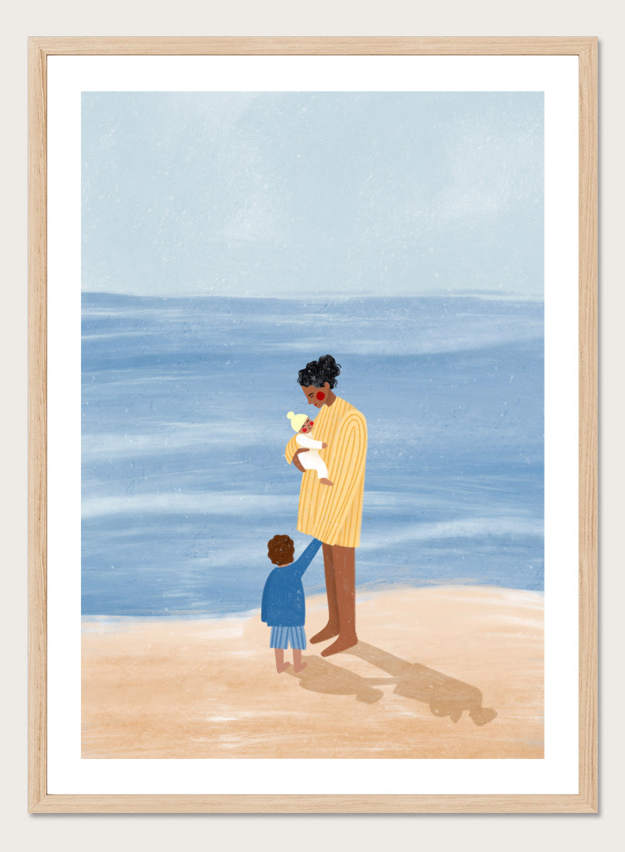 A framed art print featuring an illustration of a man in a yellow striped shirt holding a white dog on a beach next to a child in a blue coat, set against a light blue ocean and pale sky. Family Beach Day by Bea Müller art print featuring a mother with her baby and young child by the sea, created for warm family and coastal decor.