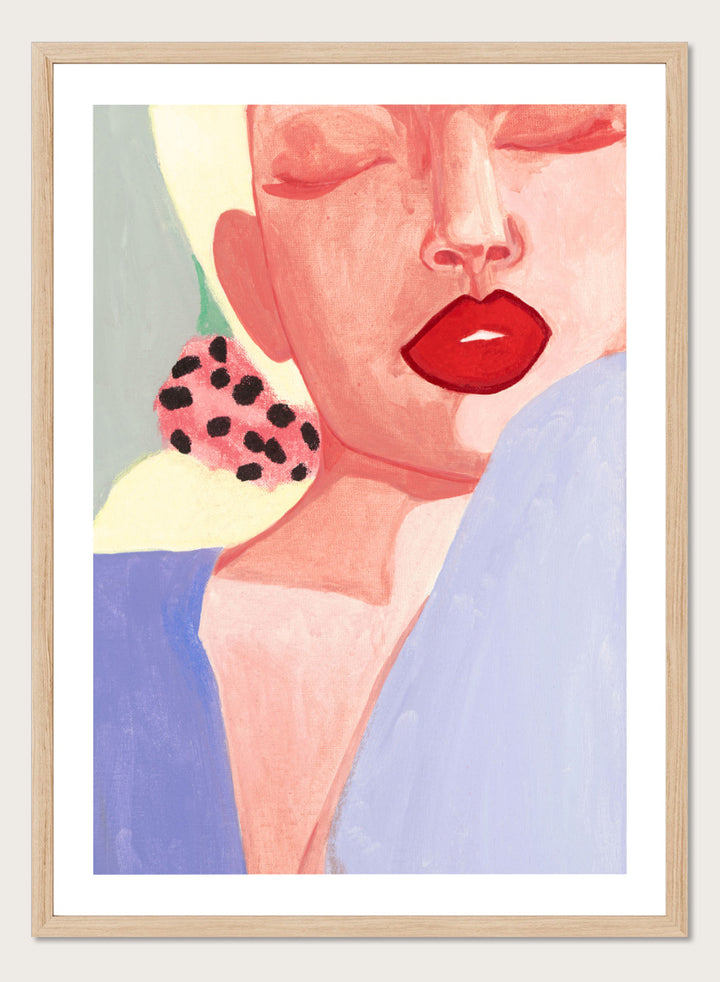 Shop Red Lips by Sophia Novosel, a modern woman portrait wall art print poster featuring bold red lips, closed eyes, soft pink tones, and a spotted earring.
