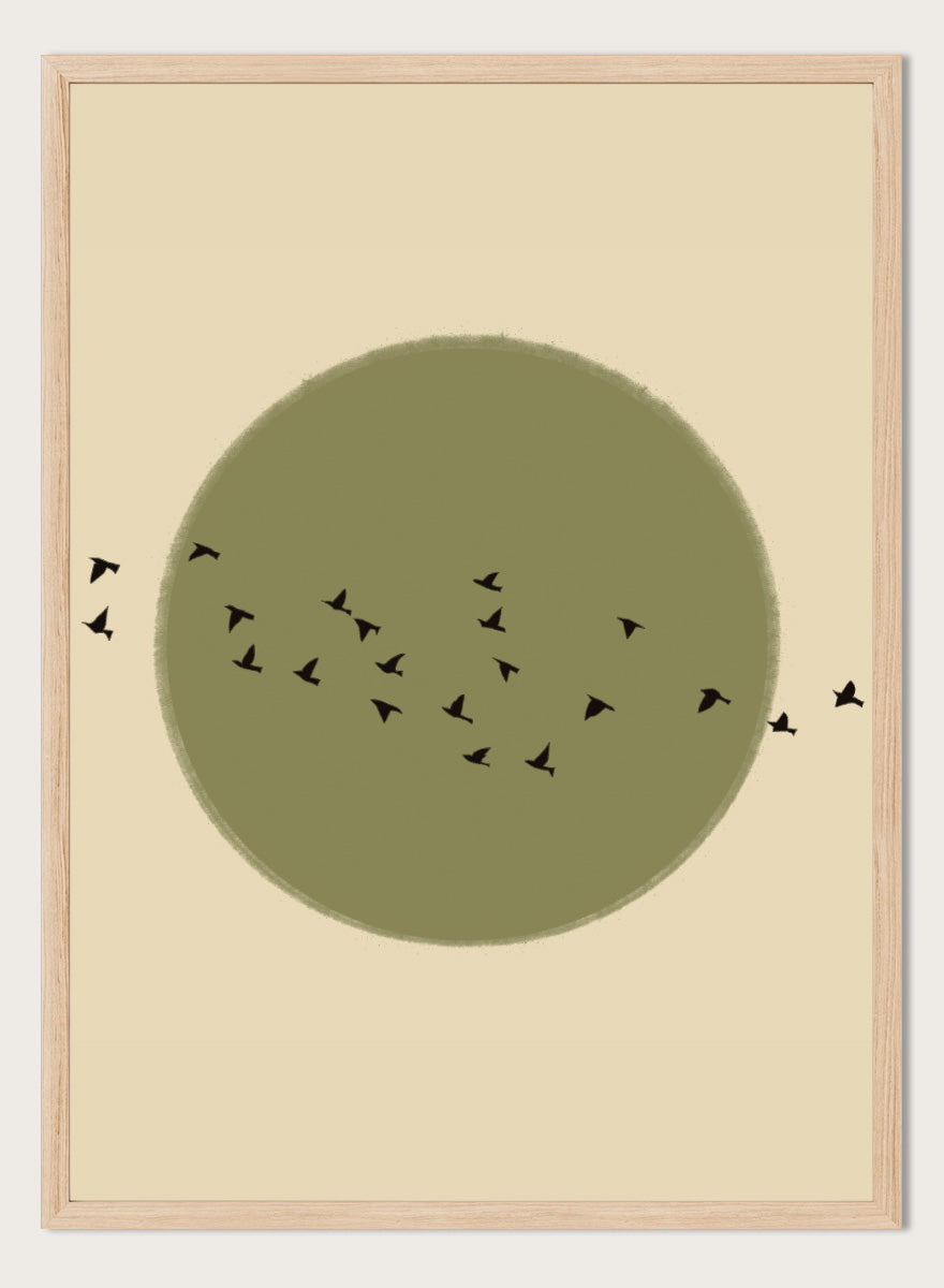 Minimalist art print featuring a large olive green circle with small black bird silhouettes flying across it, set against a warm beige background. Graceful Birds Soaring by The Art Concept is a minimalist bird art print featuring black birds in flight across an olive green circle and warm cream background.