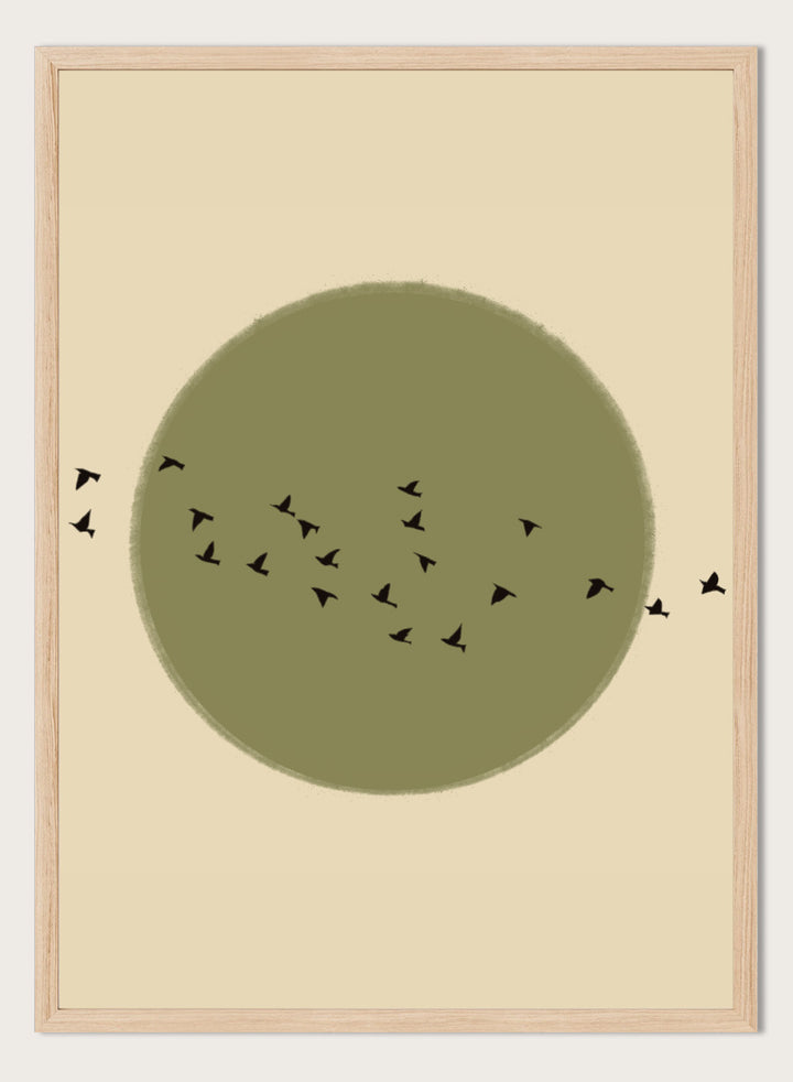 Minimalist art print featuring a large olive green circle with small black bird silhouettes flying across it, set against a warm beige background. Graceful Birds Soaring by The Art Concept is a minimalist bird art print featuring black birds in flight across an olive green circle and warm cream background.