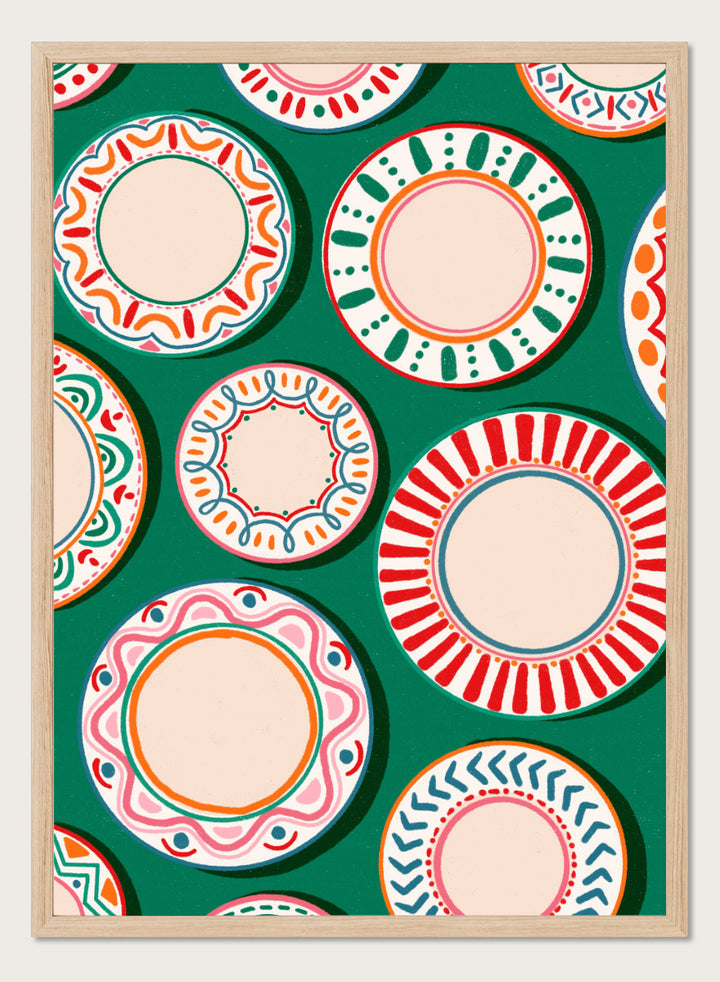A flat-lay pattern of colorful decorative plates on a dark green background, featuring a variety of circular designs in red, orange, pink, blue, and cream. Shop Colorful Patterned Plates by Nidhi Kachhadiya, a playful kitchen wall art print featuring decorative plates, folk-inspired patterns, and bold green, red, and pink tones.