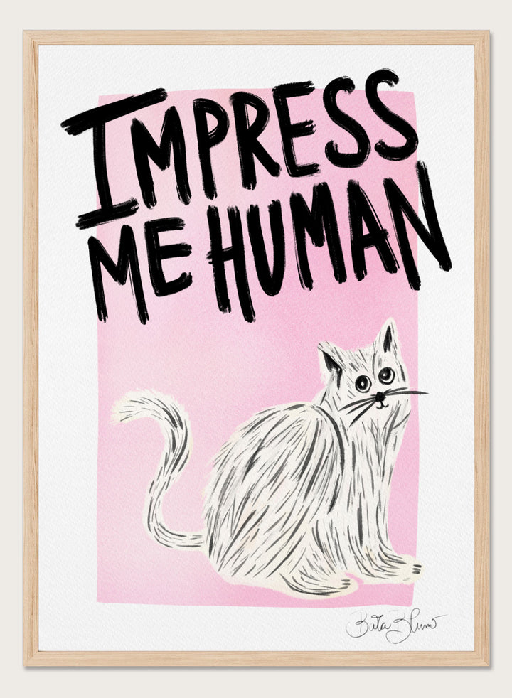 Cartoon cat with 'Impress Me Human' text on a pink background. Cat Owner. Impress Me Human by Baroo Bloom is a playful cat art print featuring hand-drawn illustration and humorous typography. Officially licensed wall poster with optional framing.
