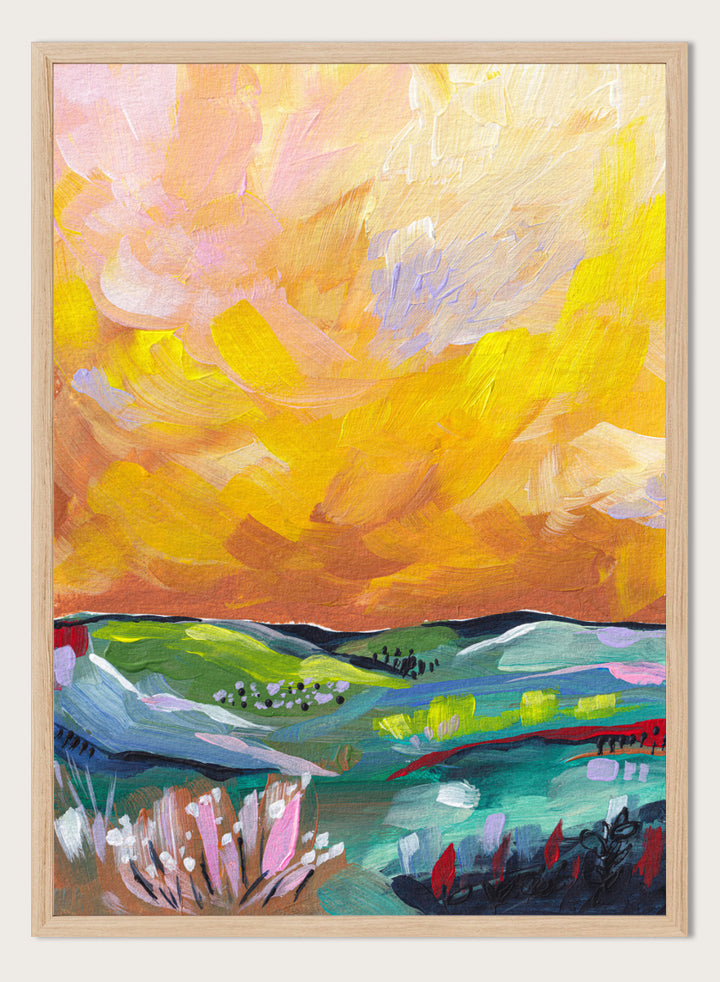An abstract landscape painting featuring a dramatic yellow and orange sky over green and blue rolling hills, with textured brushstrokes. Shop Vibrant Sunset Landscape by Dirkie Nell, a colorful landscape art print featuring rolling green hills, wildflowers, and a warm golden sunset sky.
