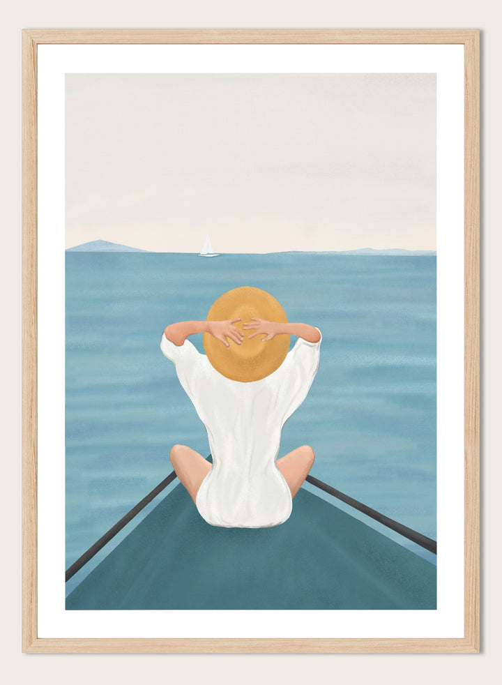 Person sitting on a dock over water wearing a white dress and straw hat. Ocean Escape by Flow Line features a woman sitting on a boat overlooking the sea, creating a coastal art print inspired by travel, summer, and ocean living.