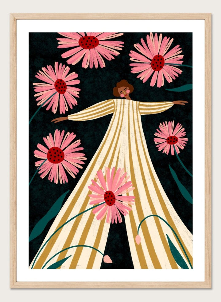 A framed art print featuring a stylized illustration of a woman in a cream and gold striped dress surrounded by large pink flowers on a dark background. Joyful Woman In Bloom by Bea Müller premium framed fine art print featuring a woman in a striped dress surrounded by oversized pink flowers.