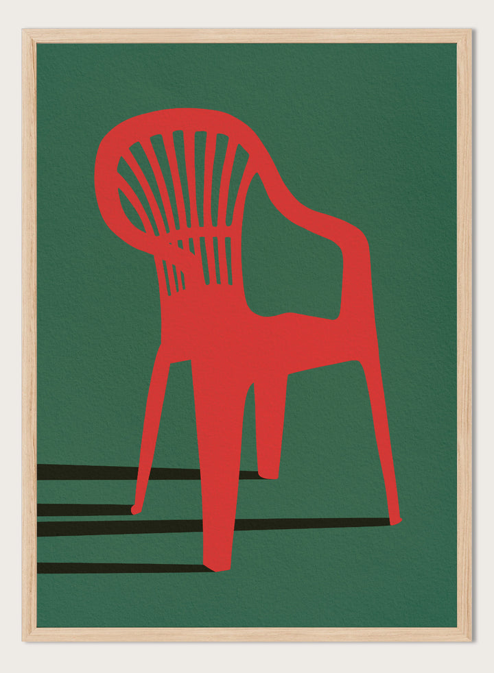 Bold Red Chair by Lisa Solomoniuk premium framed fine art print featuring a vivid red chair, deep green background, and long black shadows.