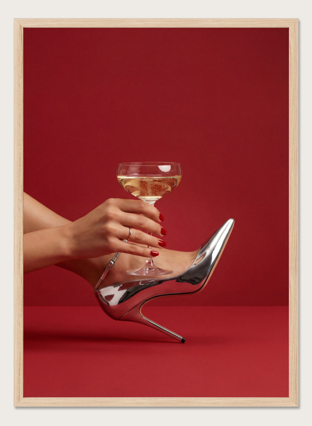 High-heeled shoe holding a glass of white wine against a red background, High Heels and Champagne by Andreas Magnusson is a fashion illustration art print featuring high heels, champagne glass imagery, bold red tones, and modern contemporary wall art style.