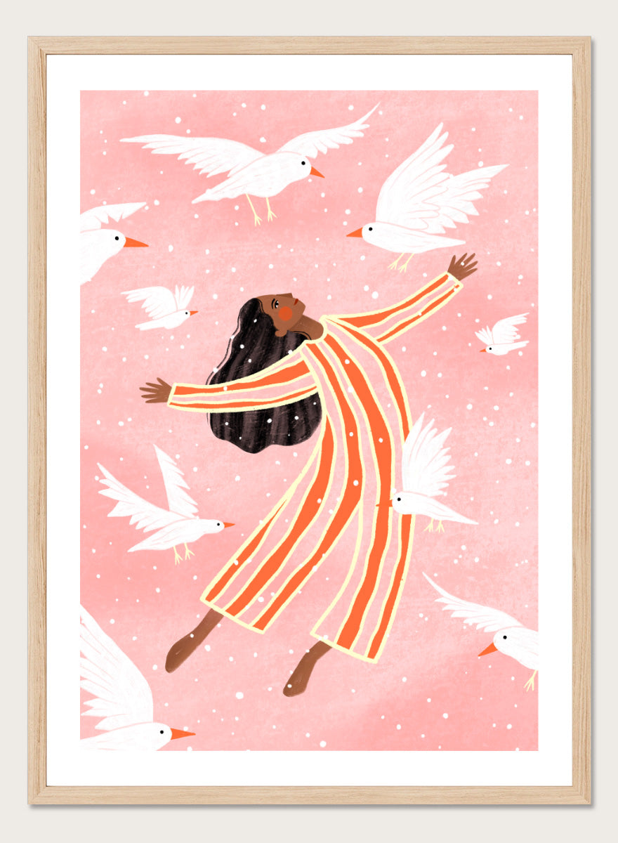 A framed art print featuring an illustration of a woman in orange and white striped pajamas floating among white doves on a soft pink background. Joyful Liberation by Bea Müller woman art print featuring a free-spirited figure surrounded by white birds in bold pink and orange tones.