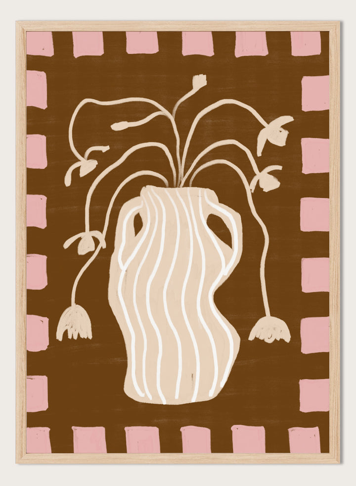 A stylized art print featuring a cream-colored wavy vase with stems and hanging flower buds on a brown background, framed by a pink and brown checkered border. Soft Floral Arrangement by The Art Concept still life art print featuring a striped vase, drooping flowers, warm brown tones, and a soft pink border.