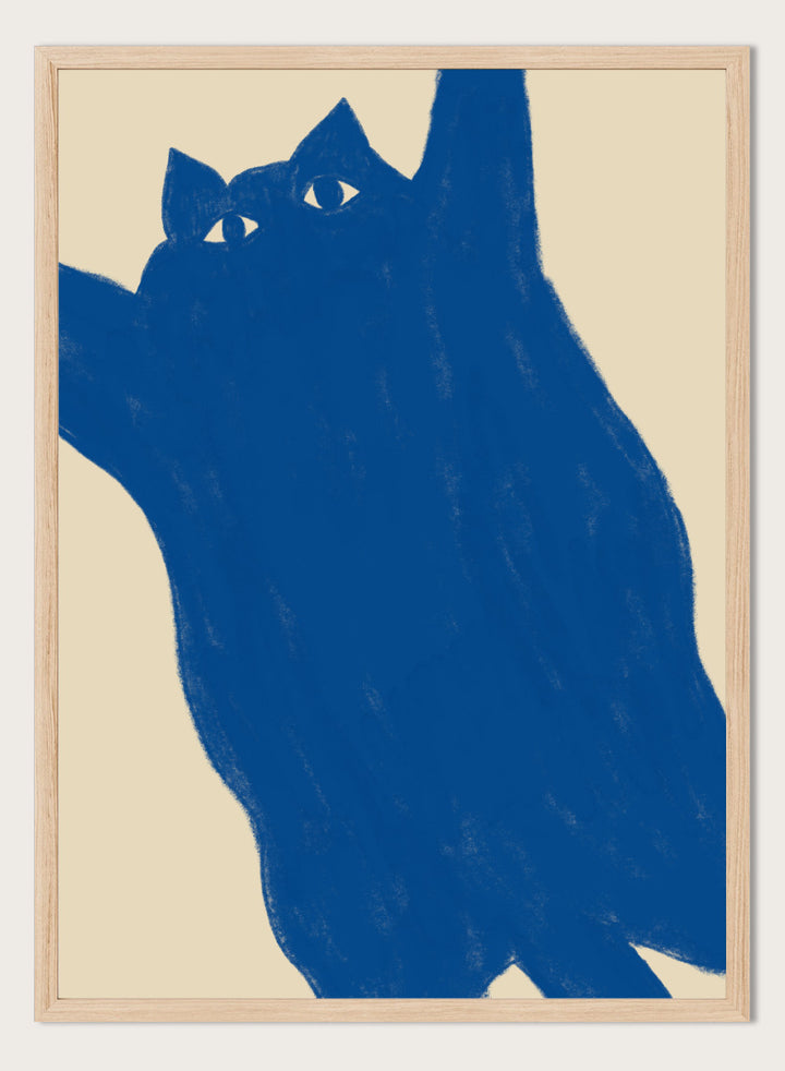 A minimalist art print featuring a bold blue cat silhouette with white eyes on a warm beige background. Playful Blue Cat by The Art Concept is a modern cat art print featuring a bold blue feline, oversized crop, and warm cream background.