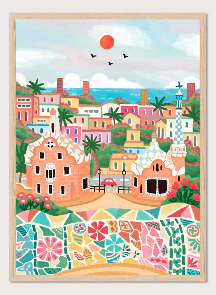 A colorful stylized illustration of a coastal town with pastel buildings, palm trees, a mosaic wall in the foreground, blue sea, and a red sun in the sky. Shop Colorful Coastal Dream by Nidhi Kachhadiya, a vibrant Barcelona wall art print inspired by Park Güell, Gaudí architecture, mosaics, and bright coastal color.