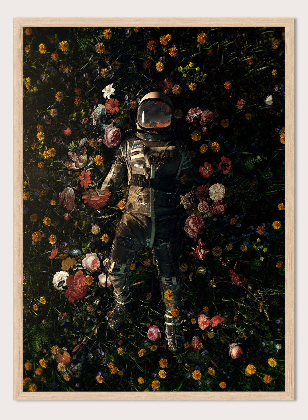 Person in a spacesuit lying on a bed of flowers with a dark background. Cosmic Floral Dream by Nicebleed is a surreal astronaut floral art print featuring a space figure surrounded by flowers, modern aesthetic wall poster.