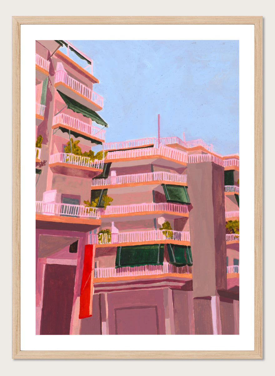 Shop Pink City Balconies by Sophia Novosel, a colorful city wall art print poster featuring pink apartment buildings, green awnings, balconies, and blue sky.