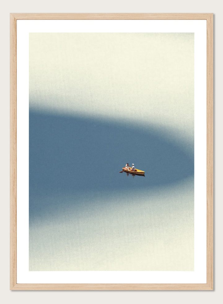 Happy Memories by Maarten Léon is an officially licensed art print featuring a minimalist boat scene with soft blue tones and open water. Available as a premium fine art print with optional real wood framing.