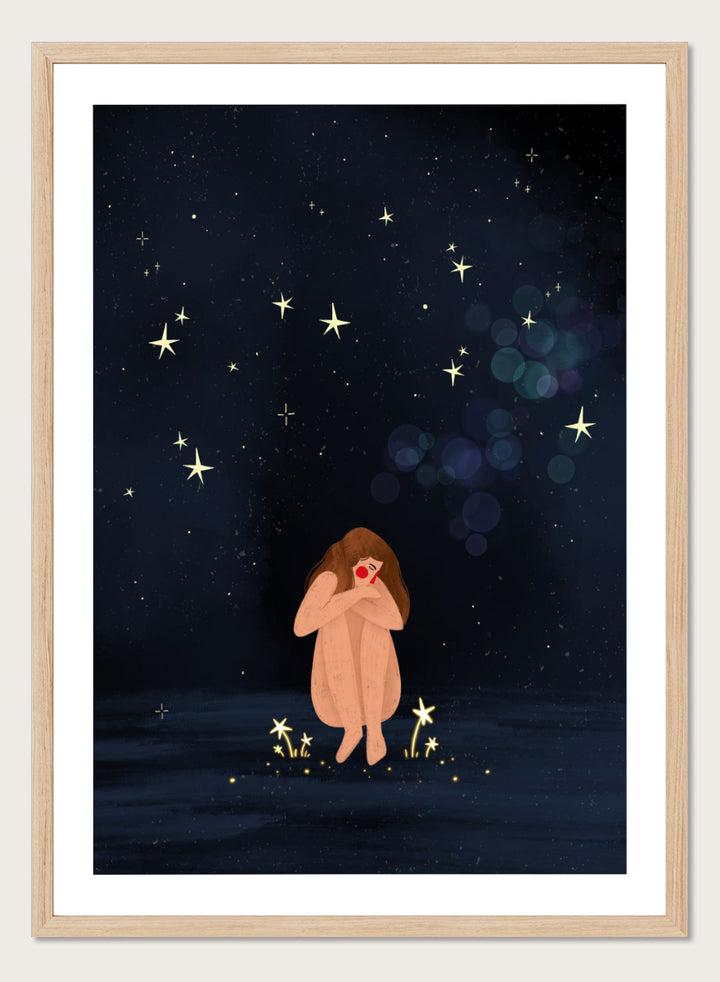 A framed art print featuring a whimsical illustration of a girl sitting on a dark blue starry night sky. Shop Starlit Solitude by Bea Müller, a figurative wall art print poster featuring a solitary woman beneath a star-filled night sky in deep blue tones.