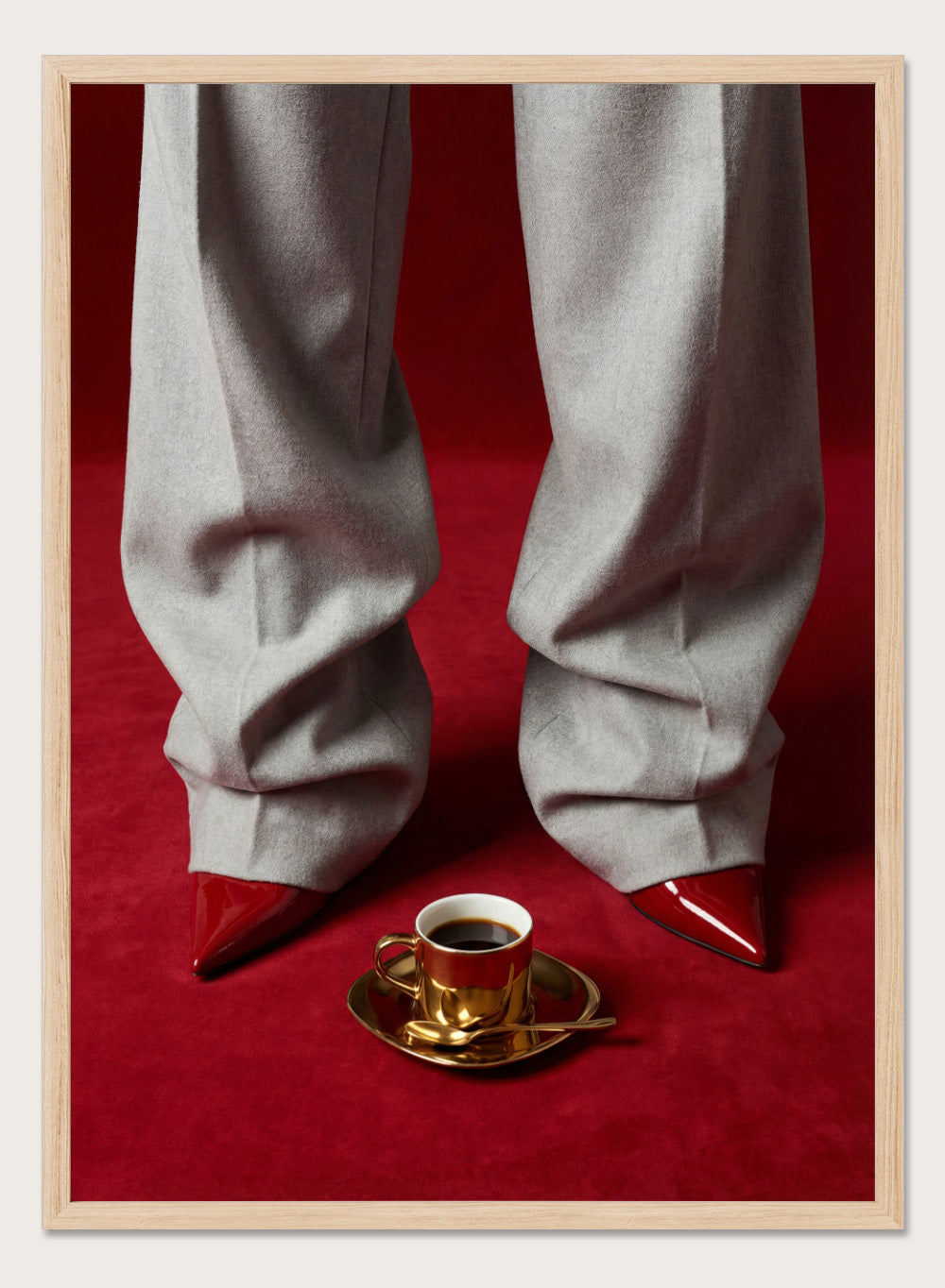 White pants with red shoes on a red carpet, featuring a gold cup and saucer with coffee. Red Shoes and Coffee by Andreas Magnusson is a fashion photography art print featuring red heels and espresso. Officially licensed modern wall poster.