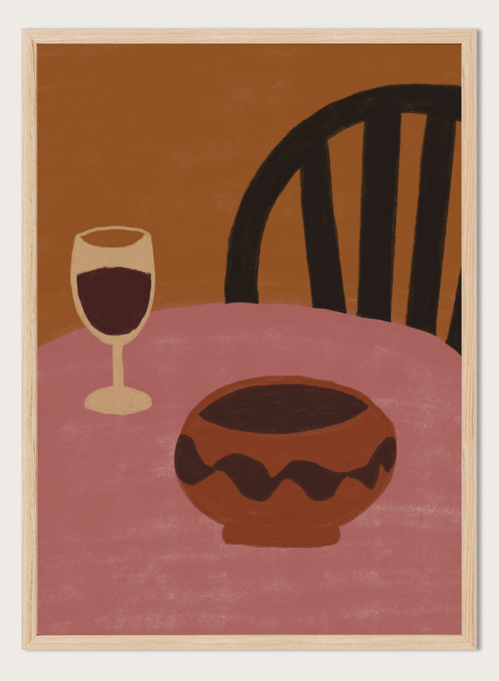A stylized still life artwork showing a pink table, a dark brown bowl in the foreground, a wine glass with deep red liquid, and a black chair against a warm brown background. Warm Dining Still Life by The Art Concept still life art print featuring red wine, a rounded bowl, pink tabletop, and rich burgundy and rust tones.