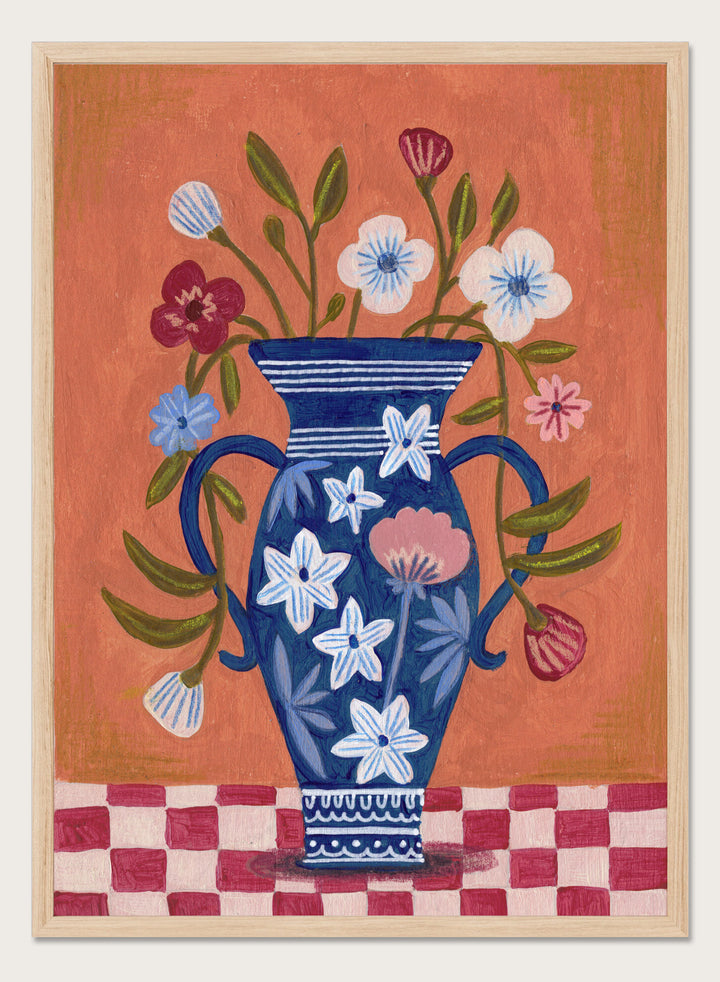 Decorative painting of a blue vase with floral patterns on a checkered floor against an orange wall. Folk Art Flower Vase by Caroline Bonne Müller is a fine art print and wall poster featuring a blue floral vase with colorful flowers on a checkered table.