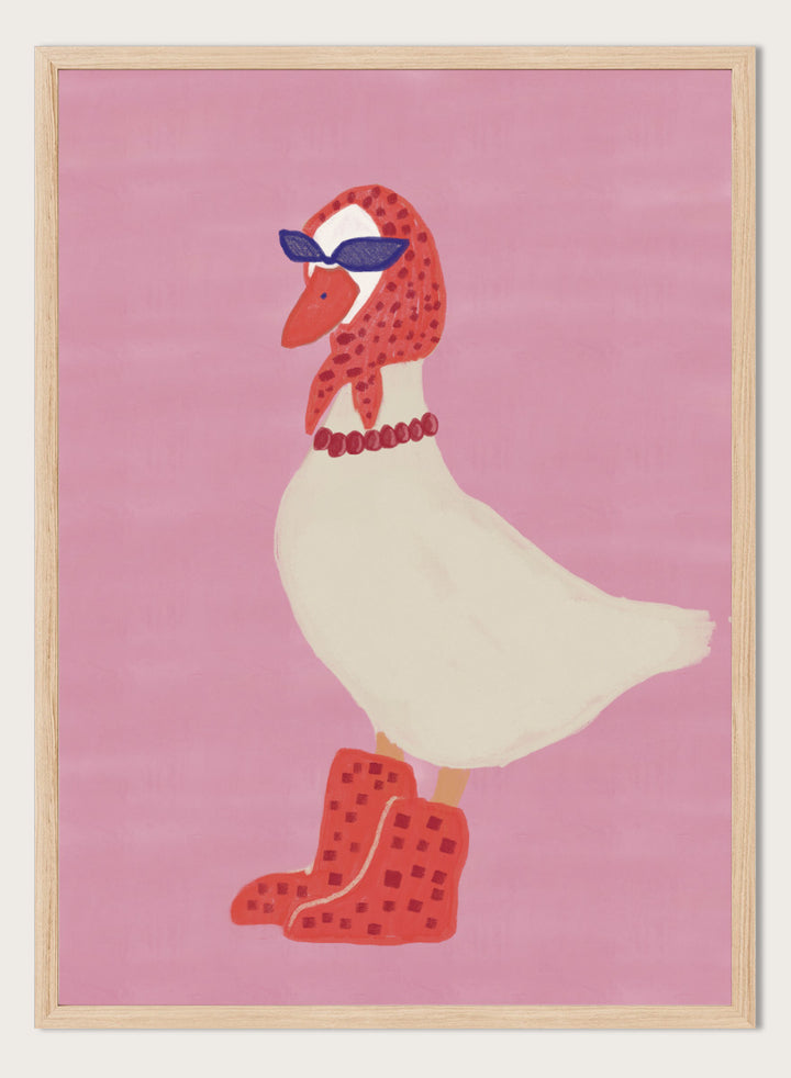 A stylized illustration of a white goose wearing a red patterned headscarf, blue sunglasses, a red beaded necklace, and red checkered boots, set against a solid pink background. Chic Goose Fashion by The Art Concept playful animal art print featuring a goose in sunglasses, a red headscarf, necklace, and bold red boots.
