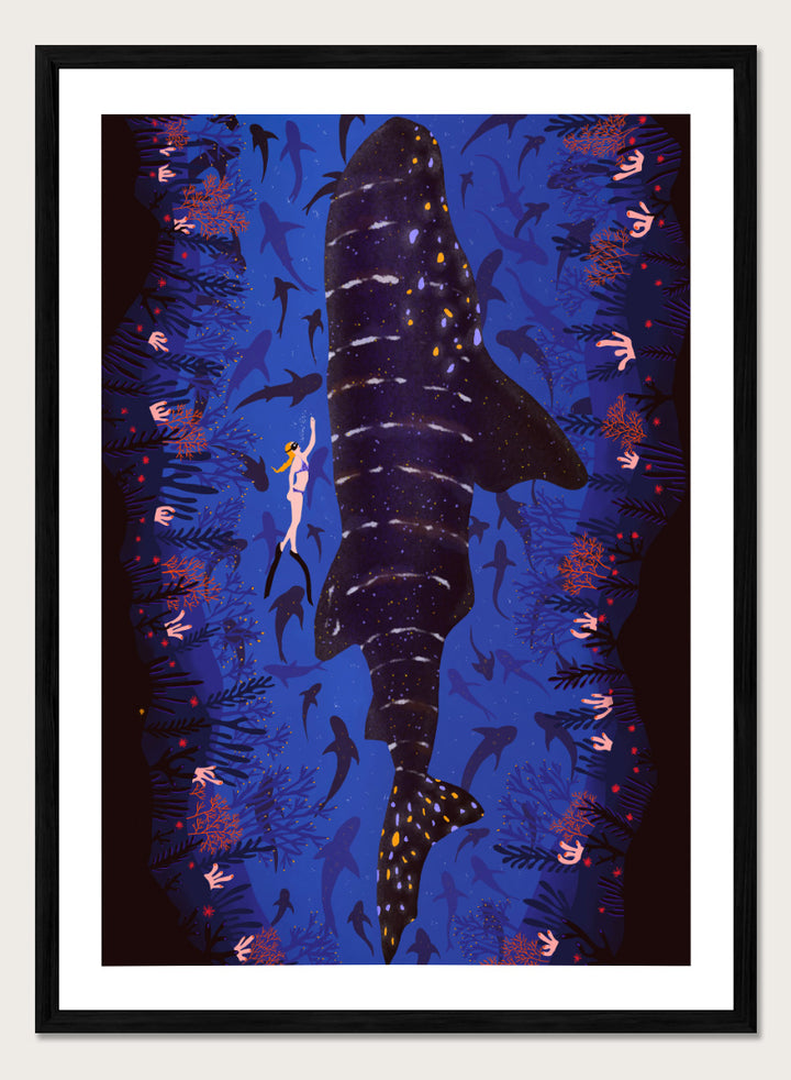 An illustrated art print featuring a large whale shark swimming through a deep blue ocean filled with smaller fish and coral. Diver and Whale Shark art print by Ceyda Alasar features a dramatic underwater view with a whale shark, diver, coral, and rich ocean blues.