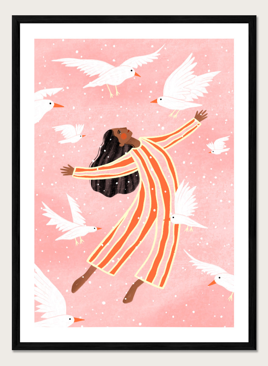 A framed art print featuring an illustration of a woman in orange and white striped pajamas floating among white doves on a soft pink background. Joyful Liberation by Bea Müller woman art print featuring a free-spirited figure surrounded by white birds in bold pink and orange tones.