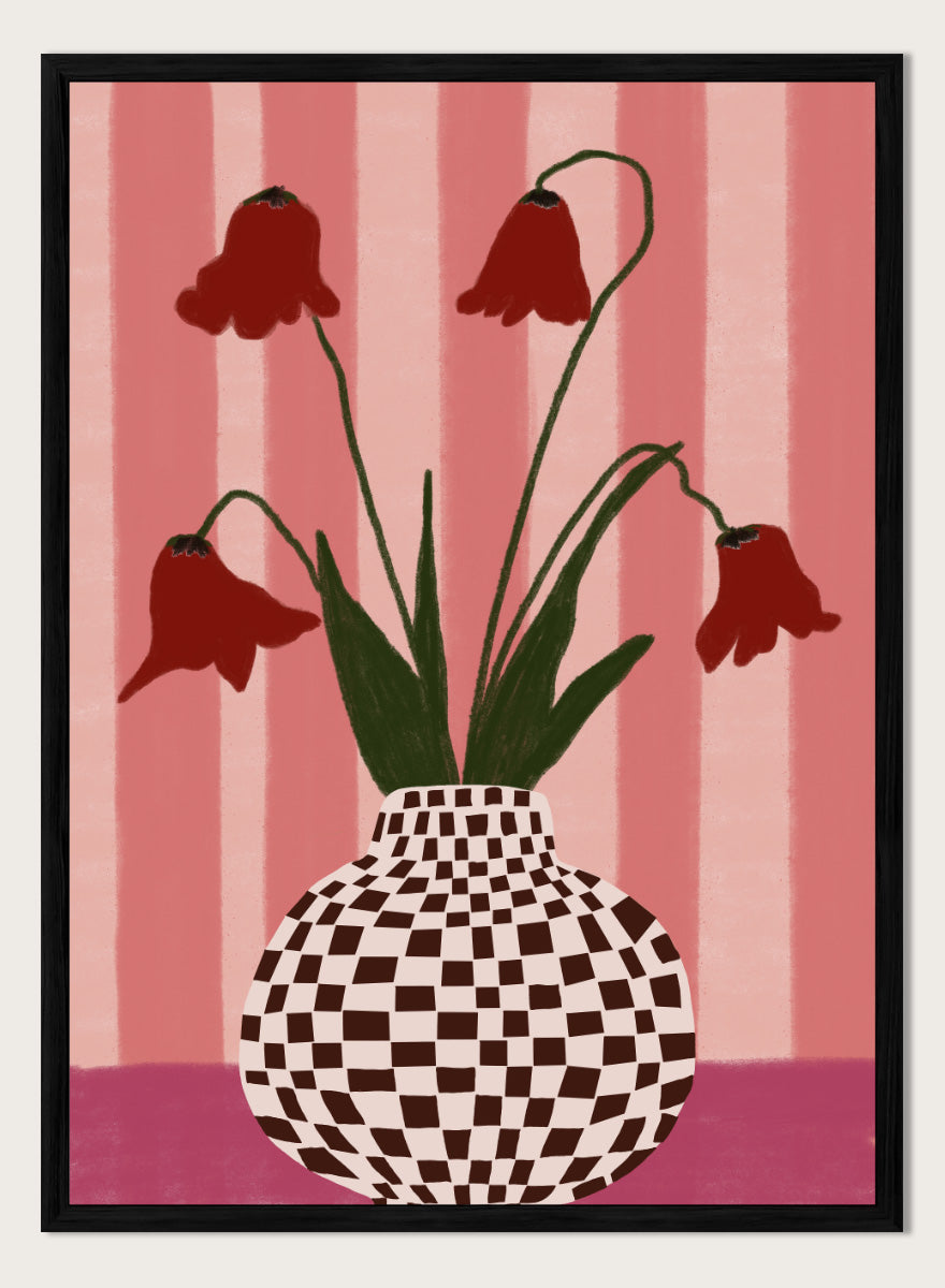 A stylized floral artwork showing four dark red bell-shaped flowers with long green stems rising from a black-and-white checkerboard vase, set against pink vertical stripes and a pink base. Whimsical Flowers Checkered Vase by The Art Concept still life art print featuring red flowers, a checkered vase, and a soft pink striped background.