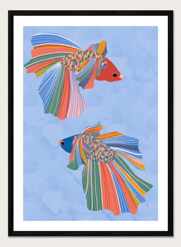 A framed art print featuring two stylized betta fish with vibrant, multicolored striped fins and bodies on a light blue water-like background. Colorful Betta Duo by Ceyda Alasar fish art print featuring two patterned betta fish with flowing fins in bright coral, blue, green, pink, and yellow.