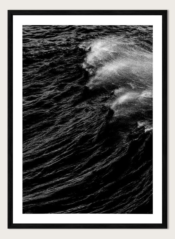 Black and white fine art photographic print of a crashing ocean wave. Dark Wave Symphony by Shot by Clint black-and-white ocean photography print featuring breaking waves, sea spray, and dramatic water texture.