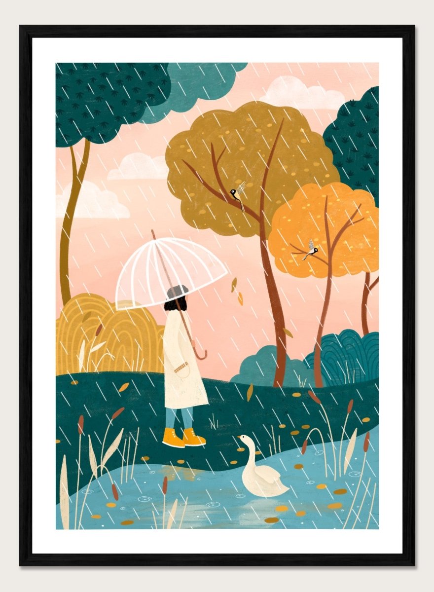A framed art print featuring a whimsical illustration of a person holding a clear umbrella in the rain near a pond with a white goose, surrounded by stylized trees in teal, mustard, and orange tones. Walking In Autumn Rain by Bea Müller premium framed fine art print featuring a woman with an umbrella beside a pond in a colorful rainy landscape.