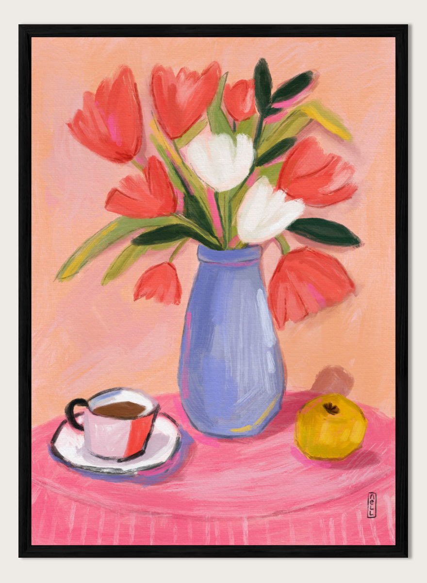 A still life painting of a bouquet of red and white tulips in a blue vase, set on a pink tablecloth next to a cup of coffee and a yellow fruit, against a peach background. Shop Fresh Tulips and Coffee by Dirkie Nell, a colorful floral still life art print featuring tulips, coffee, a blue vase, and warm pink and peach tones.