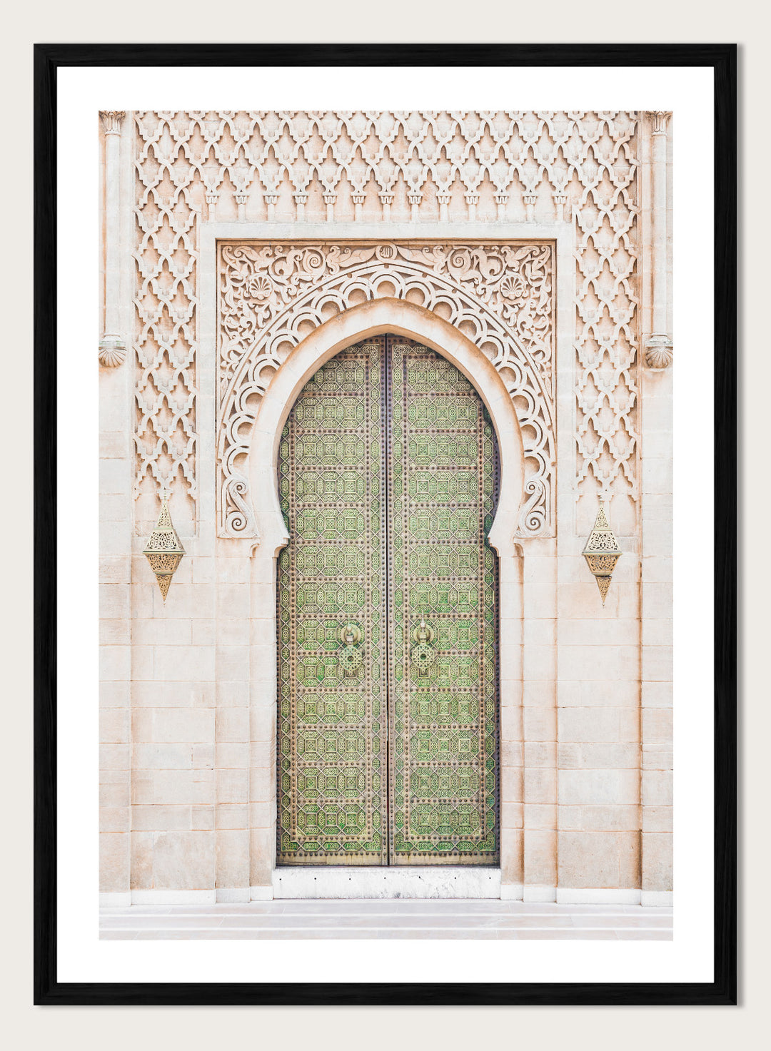 Decorative archway with ornate green door on a light stone wall. Ornate Moroccan Green Door by Henrike Schenk is a Moroccan architecture print featuring an ornate green door, Islamic patterns, and historic stone details.