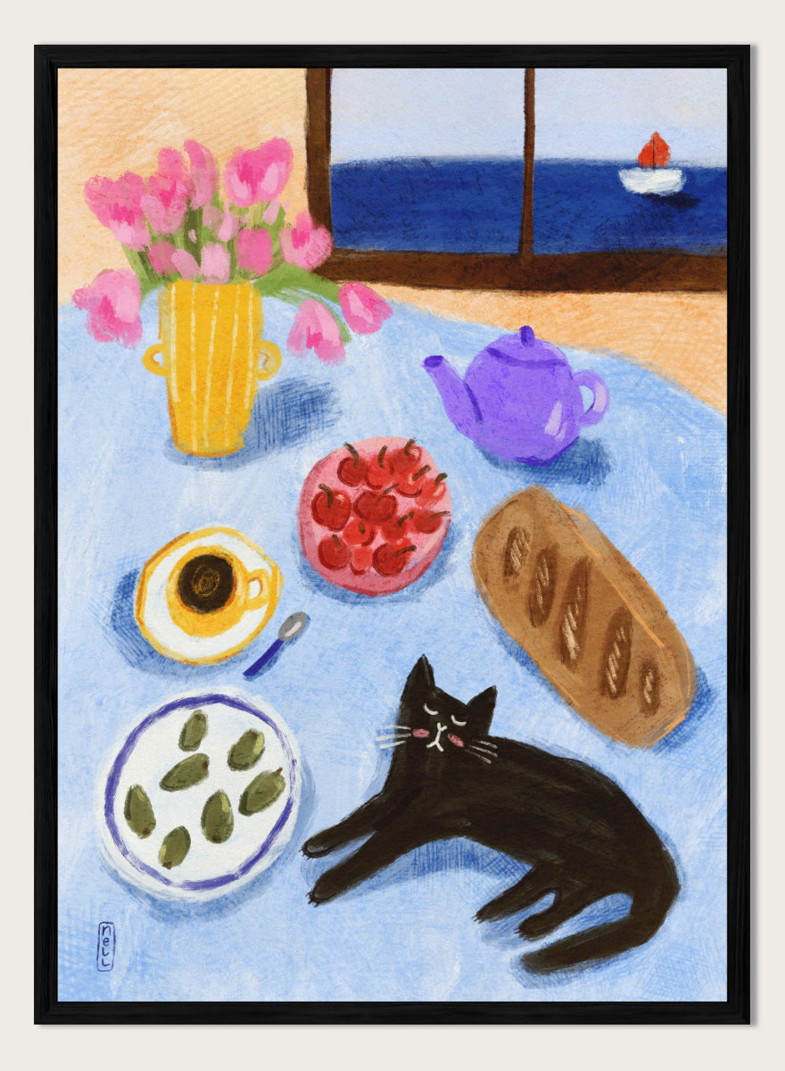 A colorful still life painting of a table scene with pink tulips in a yellow vase, a purple teapot, a bowl of strawberries, a cup of coffee, a loaf of bread, a black cat, and a window view of the sea with a small sailboat. Shop Relaxing Seaside Cat Breakfast by Dirkie Nell, a playful cat and food art print featuring breakfast, flowers, a sailboat, and a seaside view.