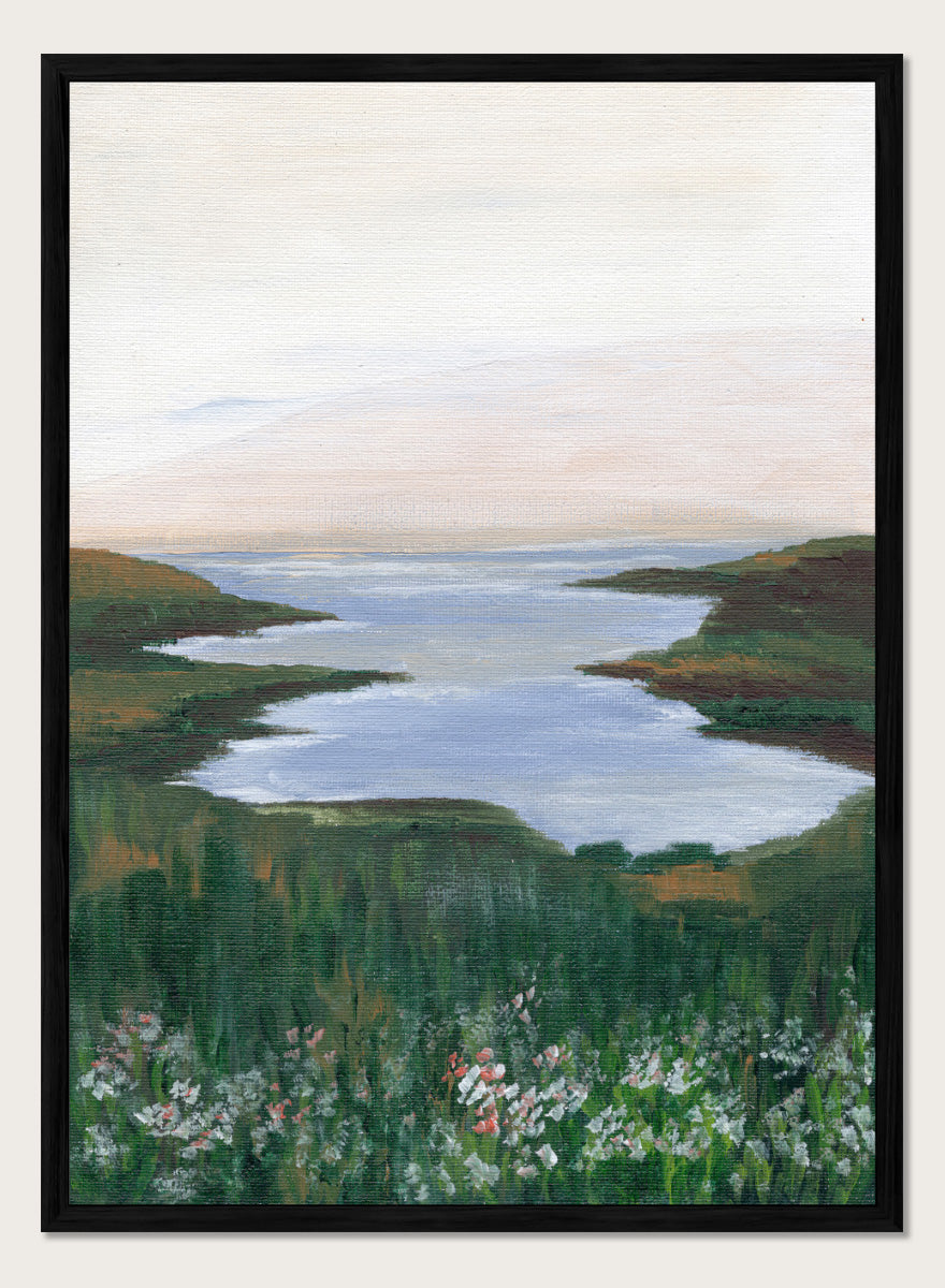 A landscape painting of a winding river or inlet between green hills, with a pale sky above and wildflowers in the foreground. Shop Wildflower Coast View by Nikita Jariwala, a coastal landscape wall art print poster featuring ocean views, green cliffs, wildflowers, and soft blue tones.