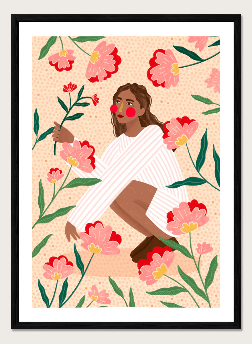 A framed art print featuring a stylized illustration of a woman in a white striped sweater surrounded by pink and red flowers on a peach background. Woman in Floral Garden by Bea Müller floral art print featuring a woman surrounded by oversized pink flowers, green leaves, and playful botanical details.