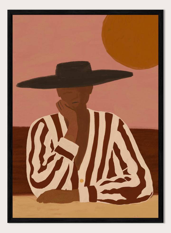 A stylized art print depicting a seated figure in a wide-brimmed black hat and a brown-and-white vertically striped shirt, set against a dusty pink sky with a large orange sun. Desert Dreamer by The Art Concept art print featuring a relaxed figure in a wide black hat, striped shirt, dusty pink sky, and warm desert-inspired tones.