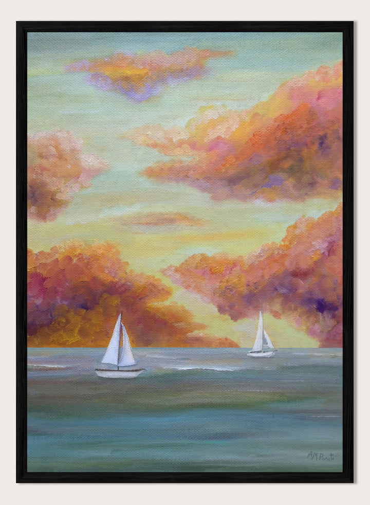 A framed painting of two white sailboats on a calm blue-green sea under a sky filled with soft, painterly clouds in pink, orange, yellow, and purple tones. Shop Sailboat Sunset Sky by Angeles M. Pomata, a coastal landscape art print featuring sailboats, calm water, and a glowing sunset sky.