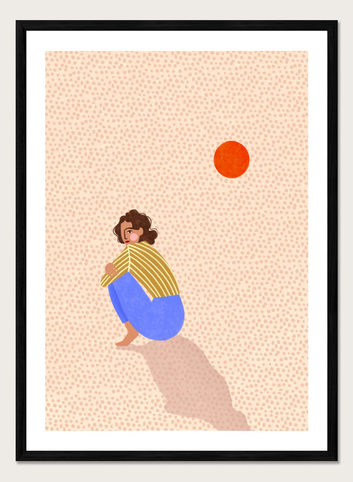 A minimalist art print featuring a stylized illustration of a person crouching in blue pants and a yellow striped top, looking up at a small orange sun against a light beige dotted background, framed with a white mat and black border. Pensive Woman Under Sun by Bea Müller art print featuring a seated woman beneath an orange sun in bold blue, mustard, and soft neutral tones.