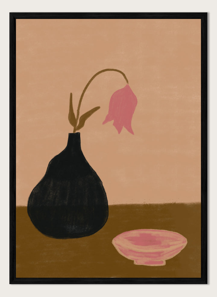 A minimalist still life painting featuring a black pear-shaped vase with a single drooping pink flower, alongside a pink bowl, set against a warm beige background and a brown tabletop. Minimal Pink Still Life by The Art Concept still life art print featuring a black vase, drooping pink flower, small bowl, and warm earthy tones.