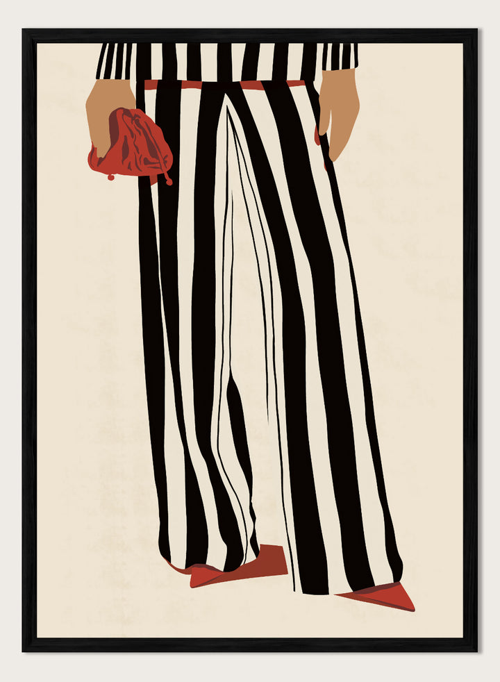 Fashion illustration of a person from the waist down wearing black and white vertically striped wide-leg trousers, with a red belt, red pointed shoes, and holding a red clutch against a cream background. Red Heels and Stripes by Lisa Solomoniuk premium framed fine art print featuring bold black-and-white stripes, pointed red heels, and a matching bag.