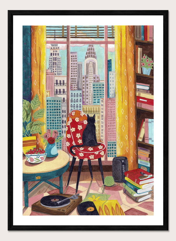 Colorful interior scene with a cat on a chair, books, and cityscape view. Black Cat City View by Caroline Bonne Müller is a fine art print and wall poster of a black cat by a window with city skyline and colorful interior.