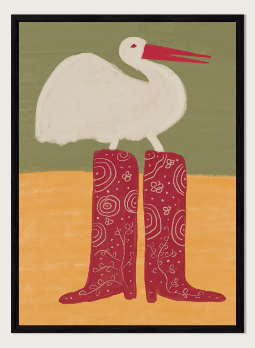 A stylized art print featuring a white stork with a red beak standing on a pair of tall red boots with white swirl patterns, set against a muted green and ochre background. Bird in Red Boots by The Art Concept playful animal art print featuring a white bird in oversized red patterned boots with soft green and ochre tones.
