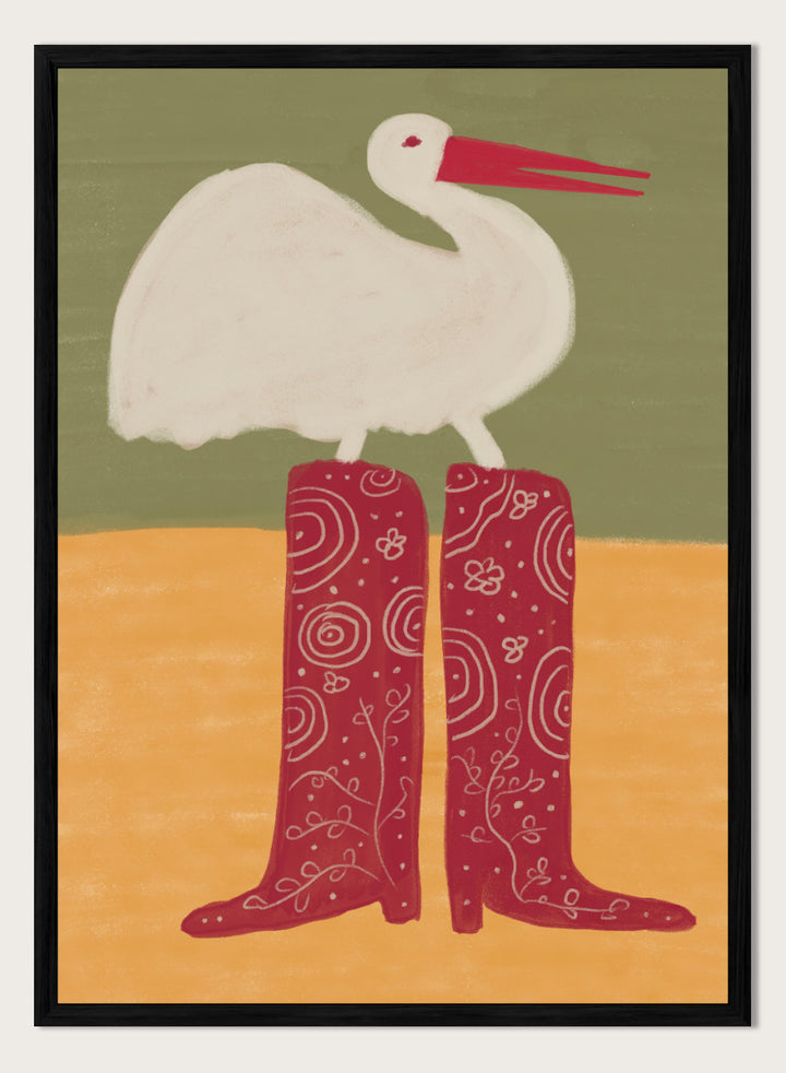 A stylized art print featuring a white stork with a red beak standing on a pair of tall red boots with white swirl patterns, set against a muted green and ochre background. Bird in Red Boots by The Art Concept playful animal art print featuring a white bird in oversized red patterned boots with soft green and ochre tones.