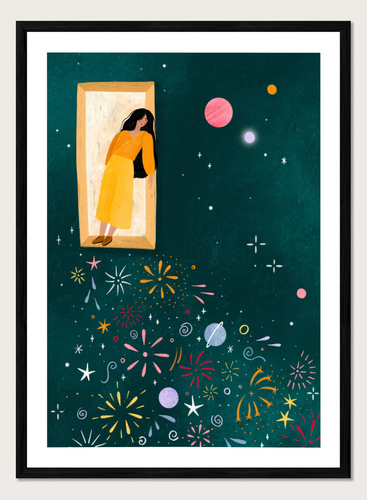A framed art print featuring a whimsical illustration of a woman in a yellow dress standing in a mirror, with her reflection spreading colorful fireworks and space-themed motifs like planets and stars across a dark teal background. Shop Girl and Cosmic Fireworks by Bea Müller, a figurative wall art print poster featuring a woman, planets, stars, and colorful cosmic fireworks in deep green tones.