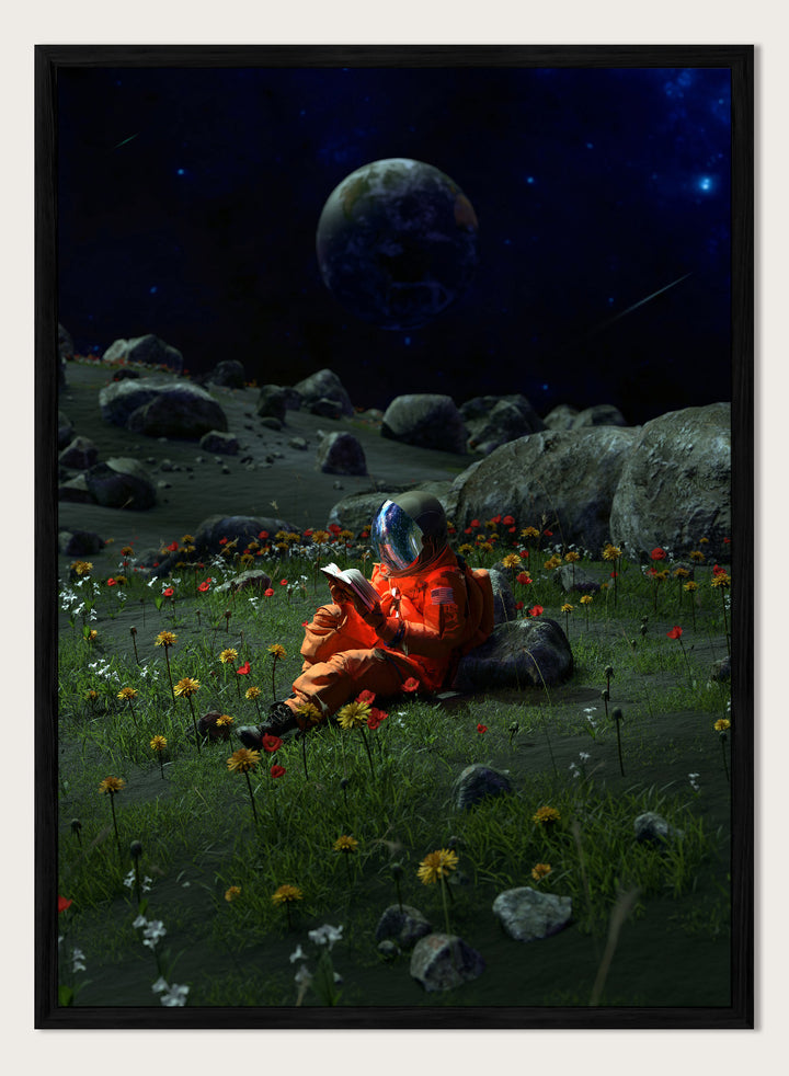 Person in orange spacesuit sitting on the moon reading a book with a large moon and stars in the background. Astronaut’s Alien Garden by Nicebleed is a surreal space art print featuring an astronaut reading in a floral alien landscape, modern aesthetic wall poster.