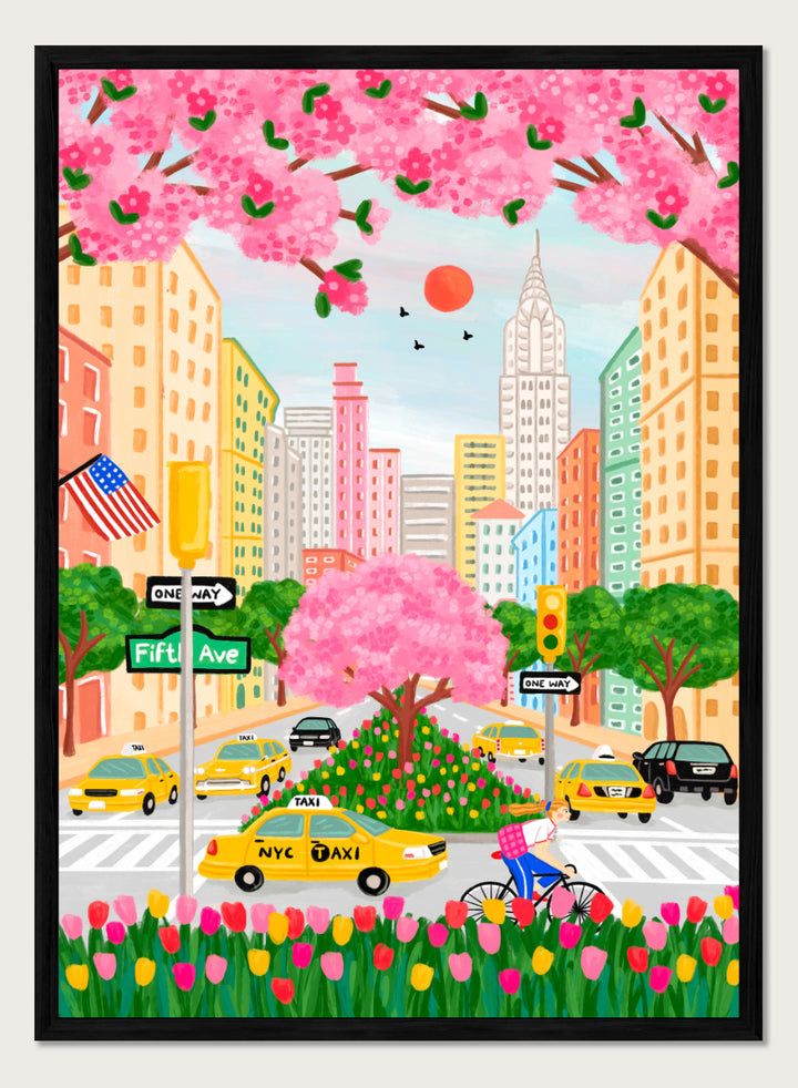 A colorful illustrated city street scene with pink cherry blossoms overhead, yellow NYC taxis, tall buildings, a bicycle with a pink basket, flowers in the foreground, and street signs including Fifti Ave. Shop NYC Cherry Blossoms by Nidhi Kachhadiya, a colorful New York City wall art print with Fifth Avenue, yellow taxis, pink blossoms, and spring city charm.